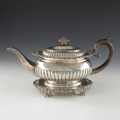 168 - A George III silver teapot on stand, J E Terrey and Co., London 1817, squat ovoid form, half reeded,... 