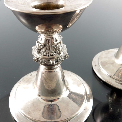 169 - A pair of Iona style silver candlesticks, Hardy Brothers, Birmingham 1965, the stepped conical bases... 