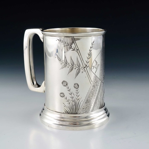 210 - An Aesthetic Movement silver plated pint mug, circa 1870, cylindrical on stepped foot, hand chased a... 