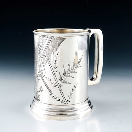 210 - An Aesthetic Movement silver plated pint mug, circa 1870, cylindrical on stepped foot, hand chased a... 