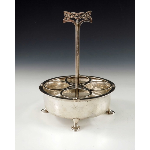 216 - Archibald Knox for Liberty and Co., an Arts and Crafts silver egg stand or cruet, Birmingham 1900, t... 