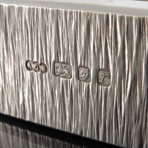 237 - Gerald Benney, a Modernist silver dish, London 1972, cuboid form, bark textured sides, with cushione... 