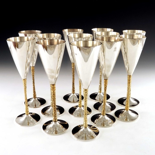 238 - Stuart Devlin, a matched set of twelve Modernist silver and parcel gilt champagne flutes, London 197... 