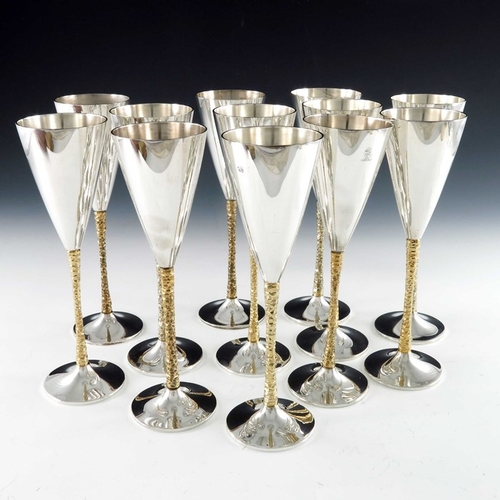 238 - Stuart Devlin, a matched set of twelve Modernist silver and parcel gilt champagne flutes, London 197... 