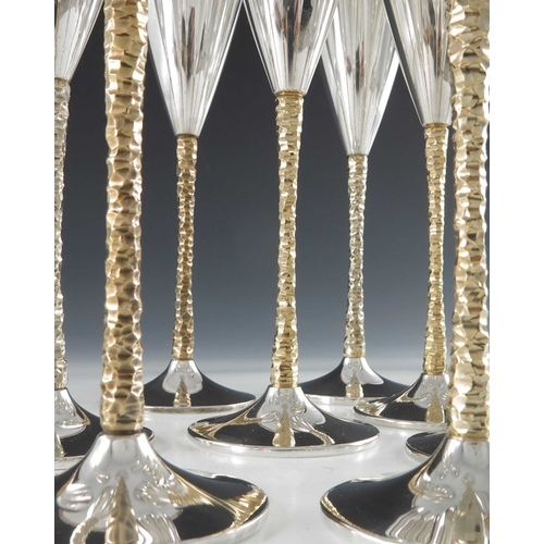 238 - Stuart Devlin, a matched set of twelve Modernist silver and parcel gilt champagne flutes, London 197... 