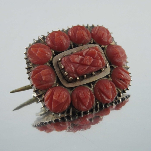 243 - A 19th century gold and carved coral brooch, together with a carved drop pendant, 4cm long (2)