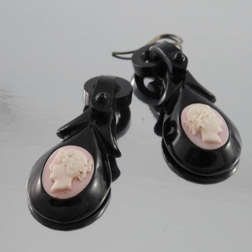 244 - A pair of late Victorian jet and conch shell cameo earrings, oval pink and white opposing bust portr... 