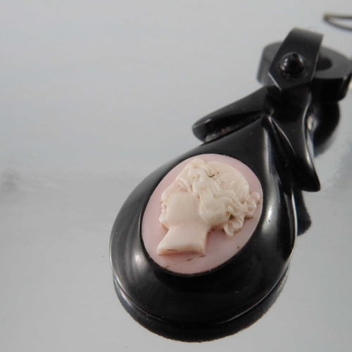 244 - A pair of late Victorian jet and conch shell cameo earrings, oval pink and white opposing bust portr... 