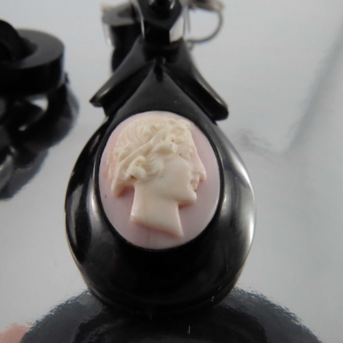 244 - A pair of late Victorian jet and conch shell cameo earrings, oval pink and white opposing bust portr... 