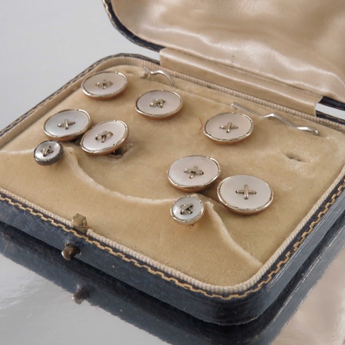 259 - A set of 18 carat gold, 9 carat and mother of pearl studs, buttons and cufflinks, in the form of shi... 