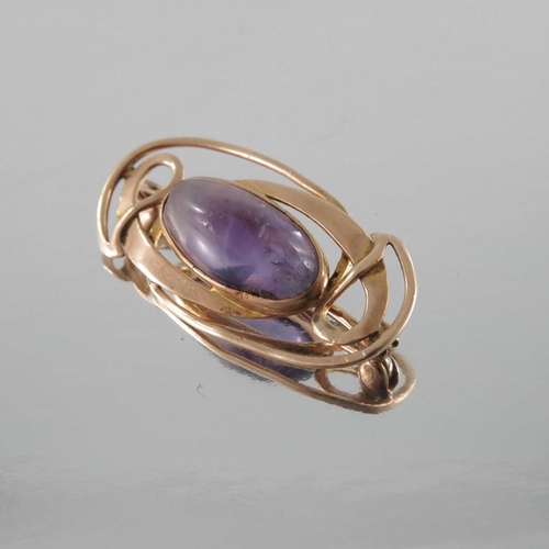 273 - Archibald Knox for Liberty and Co., an Arts and Crafts amethyst and gold brooch, the central cabocho... 