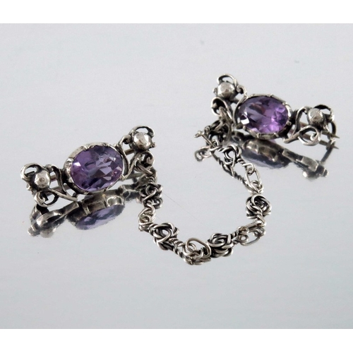 278 - Sybil Dunlop (attributed), an Arts and Crafts silver and amethyst chain brooch, circa 1910, the two ... 