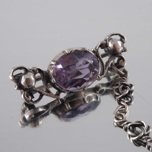 278 - Sybil Dunlop (attributed), an Arts and Crafts silver and amethyst chain brooch, circa 1910, the two ... 