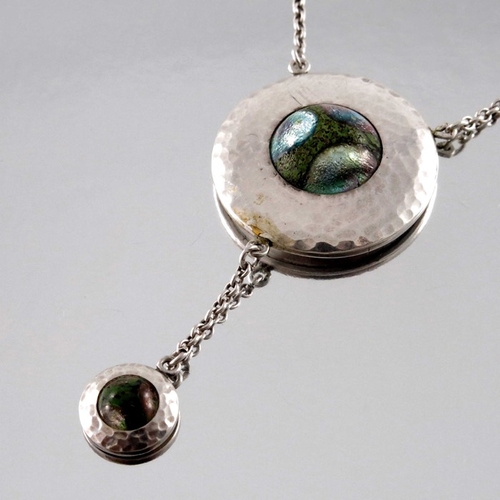 283 - A Secessionist style silver and enamelled necklace, the circular pendant, planished and set with a c... 