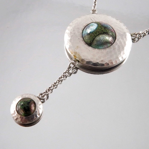 283 - A Secessionist style silver and enamelled necklace, the circular pendant, planished and set with a c... 