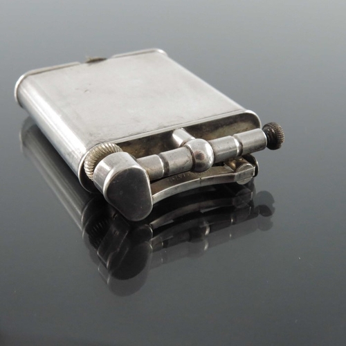 296 - Alfred Dunhill, a New Dunhill lift arm lighter, silver plated, circa 1930s, 5.5cm high