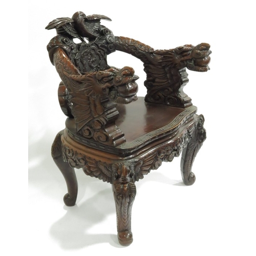 370 - An Oriental carved hardwood armchair, circa 1851, modelled in relief with dragons and birds, pierced... 