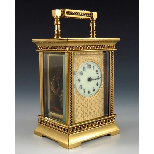 392 - A French gilt brass carriage timepiece, the 1.5 inch cream enamelled dial within an etched fleur de ... 