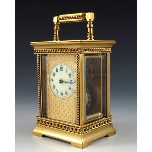 392 - A French gilt brass carriage timepiece, the 1.5 inch cream enamelled dial within an etched fleur de ... 