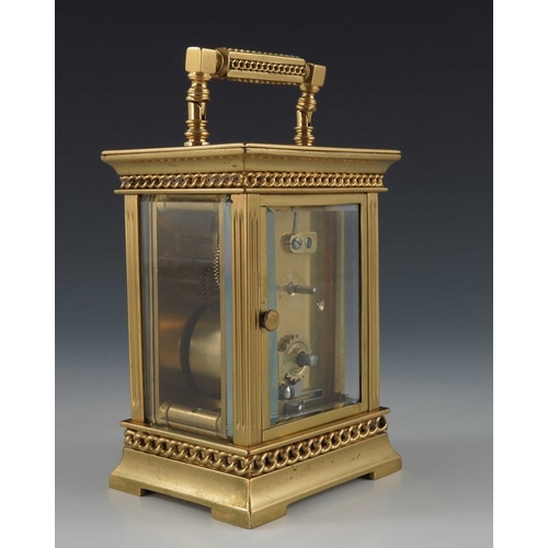 392 - A French gilt brass carriage timepiece, the 1.5 inch cream enamelled dial within an etched fleur de ... 