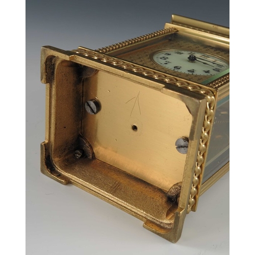 392 - A French gilt brass carriage timepiece, the 1.5 inch cream enamelled dial within an etched fleur de ... 