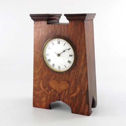 395 - An Arts and Crafts oak and marquetry clock, tapered form with fret carved ogee domed bracket feet, a... 