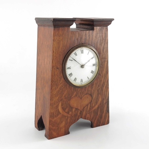 395 - An Arts and Crafts oak and marquetry clock, tapered form with fret carved ogee domed bracket feet, a... 