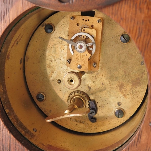 395 - An Arts and Crafts oak and marquetry clock, tapered form with fret carved ogee domed bracket feet, a... 