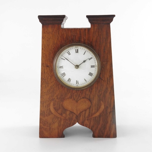 395 - An Arts and Crafts oak and marquetry clock, tapered form with fret carved ogee domed bracket feet, a... 