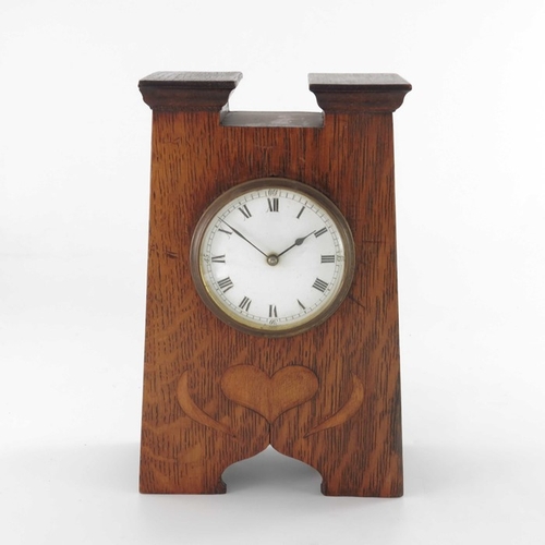 395 - An Arts and Crafts oak and marquetry clock, tapered form with fret carved ogee domed bracket feet, a... 