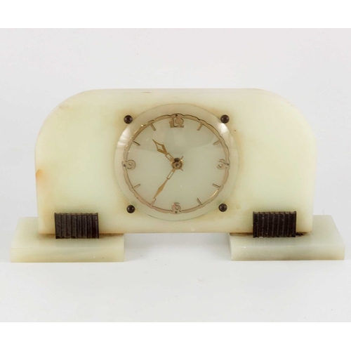 396 - An Art Deco onyx and bronze clock, Garrard and Co., shaped rectangular slab form with fretted gilt c... 