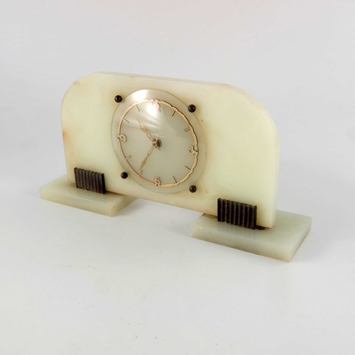 396 - An Art Deco onyx and bronze clock, Garrard and Co., shaped rectangular slab form with fretted gilt c... 