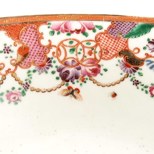 404 - An 18th century Chinese famille rose punch bowl, Qianlong, painted with trellis cartouches and husk ... 