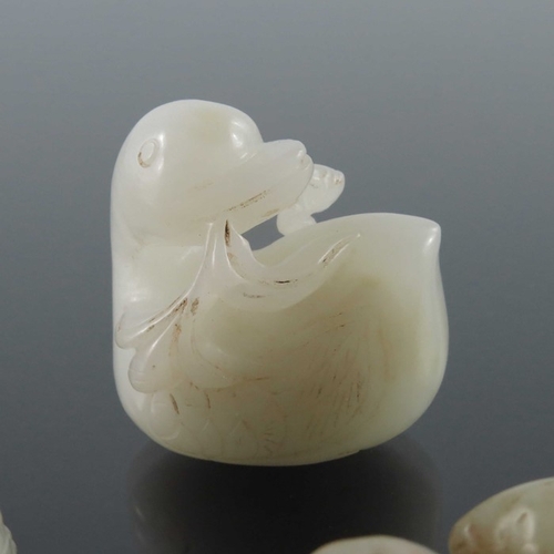 406 - Three Chinese jade carvings, including man with a stick, man with monkey and a duck, pierced and eng... 