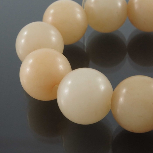 407 - A set of Chinese carved jade beads, uniform spherical form, eleven beads approx 2cm diameter (11)