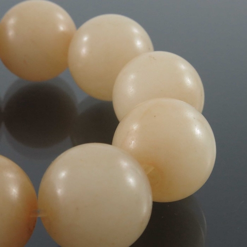 407 - A set of Chinese carved jade beads, uniform spherical form, eleven beads approx 2cm diameter (11)