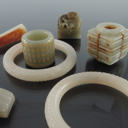 408 - A collection of Chinese jade and hardstone carvings, including archers ring, bangles, seals etc., ba... 