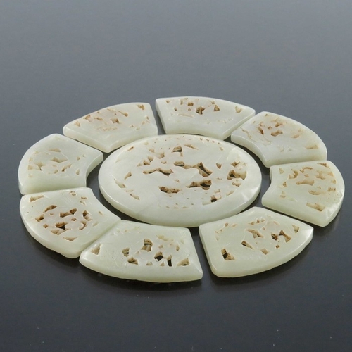 409 - A Chinese reticulated carved jade sectional rosette, the central disc with peacocks and flowers, the... 