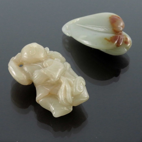 410 - Two Chinese carved jade pendants, one as a group of peaches, the other of a man and boy with ruyi sc... 