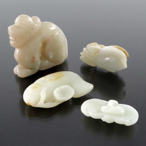 411 - Four Chinese jade carvings and pendants, including fish, dog and peaches, pierced and incised, 8.5cm... 