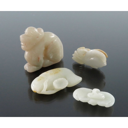 411 - Four Chinese jade carvings and pendants, including fish, dog and peaches, pierced and incised, 8.5cm... 