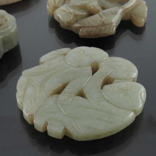 412 - Four Chinese carved jade pendants, some reticulated, including an incised ring medallion, figures an... 