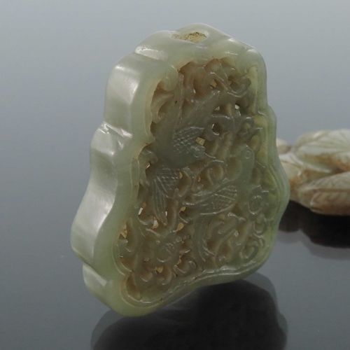 412 - Four Chinese carved jade pendants, some reticulated, including an incised ring medallion, figures an... 