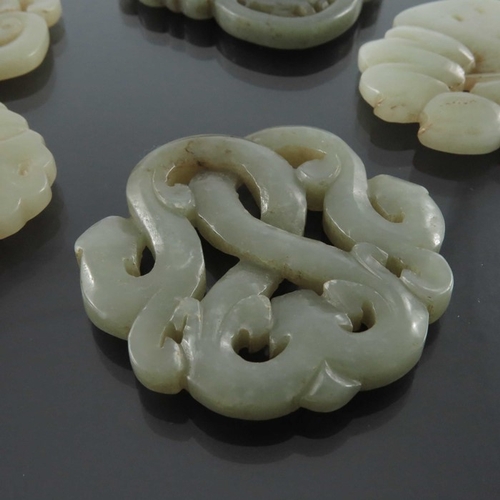 414 - Five Chinese reticulated carved jade pendants, including knotted serpent and foliate designs, 7cm (5... 