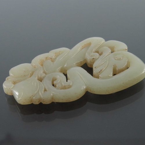 414 - Five Chinese reticulated carved jade pendants, including knotted serpent and foliate designs, 7cm (5... 