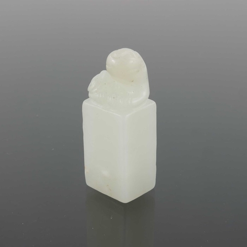 416 - Two Chinese carved jade seals, both with lions to the finials, one white, 4.5cm high (2)