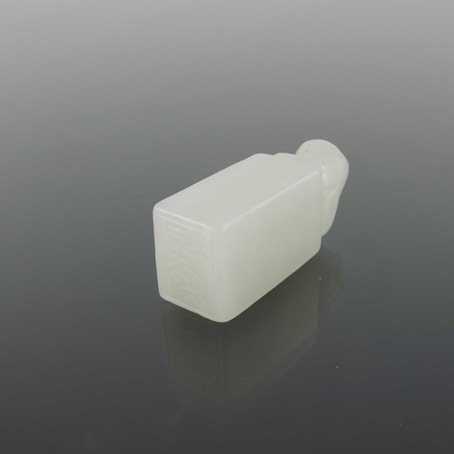 416 - Two Chinese carved jade seals, both with lions to the finials, one white, 4.5cm high (2)