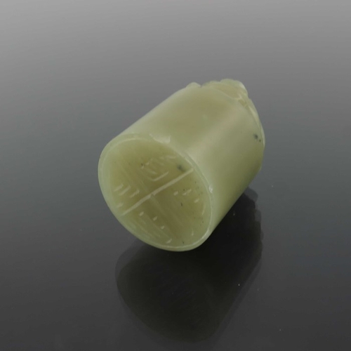 416 - Two Chinese carved jade seals, both with lions to the finials, one white, 4.5cm high (2)