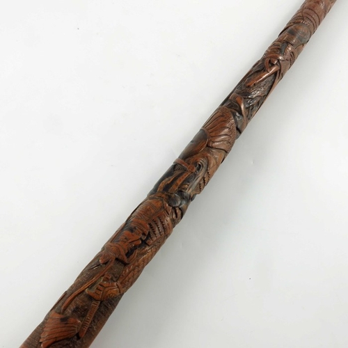 425 - A Japanese carved bamboo cane, Meiji, decorated in the round with battling Samurai, signed, 89cm lon... 