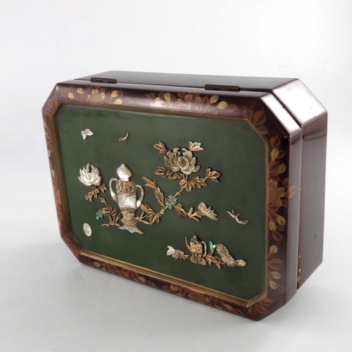 426 - A Japanese lacquer and shibayama box, chamfered cuboid form, the lid decorated with a vase and chrys... 